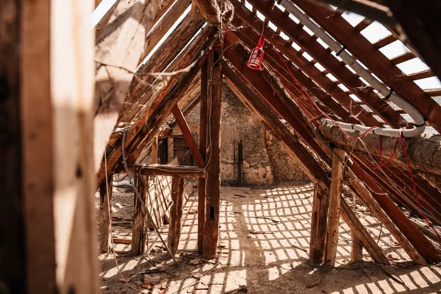 Sunlight through the rafters of a hot loft roof space