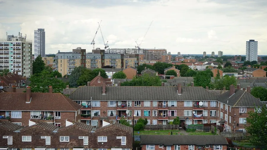 Aerial view of dense London rooftops holding heat on a summer evening
