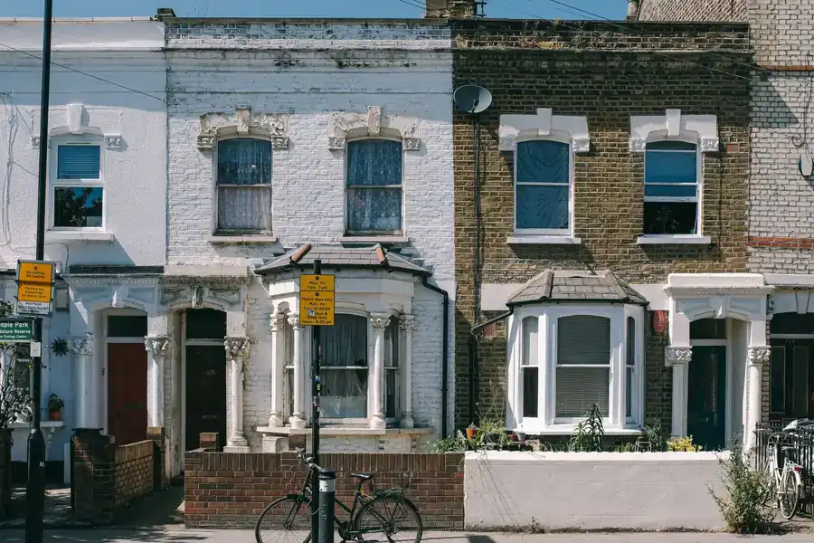 Terrace roofline of older London brick houses showing a continuous run of clay tiles
