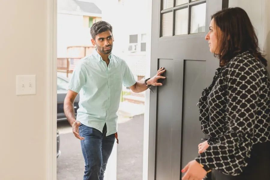 Two flat owners in a Croydon conversion discussing who pays for the roof repair