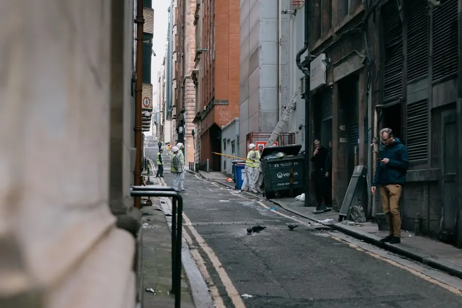 Pedestrians passing a pavement kept clear alongside building work