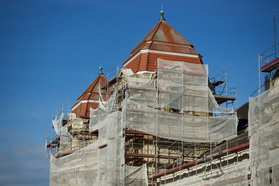 Scaffolding and sheeting around a building during major roof works