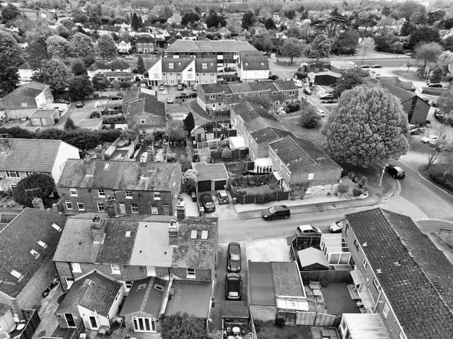 Rooftops of terraced houses seen from above with paired rear additions meeting along the boundary
