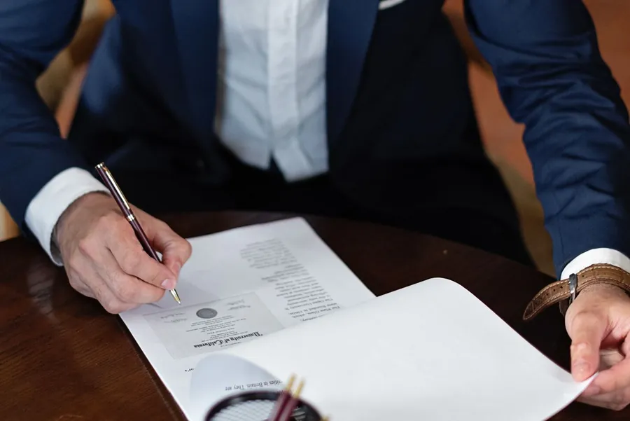 A seller signing the property information form for a house sale