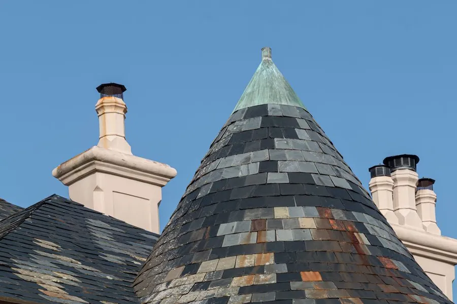 Slate roof and chimney stacks in Croydon where valleys collect leaves and debris