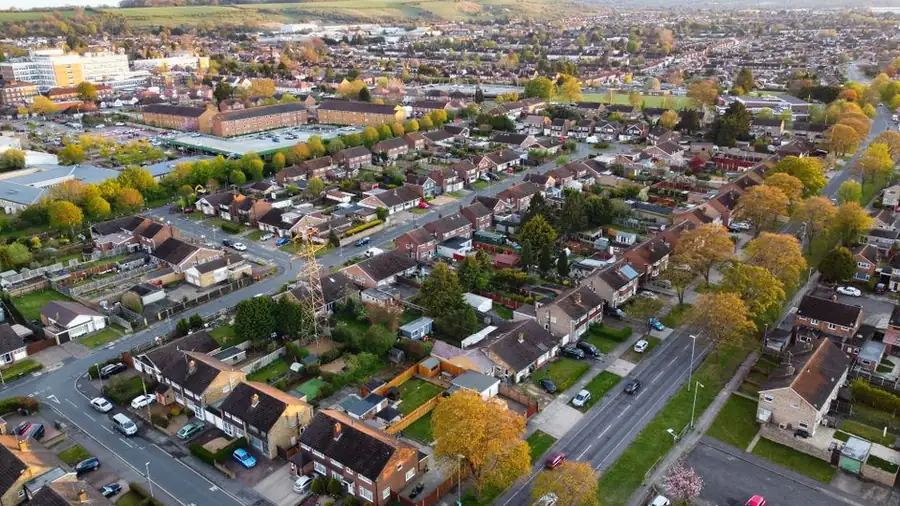 Aerial view of tree-lined suburban streets and rooftops in Croydon during autumn