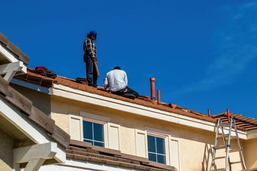 A roofer working on the ridge of a house roof in Croydon