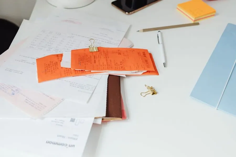 A written itemised roofing quote and paperwork on a table