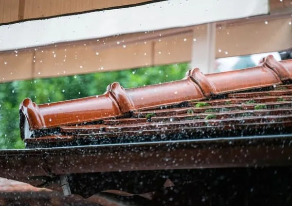 Rainwater overflowing a blocked gutter on a house in Croydon