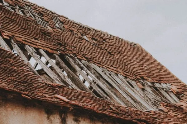 Roof with storm damage in Croydon, tiles gone and battens exposed to the weather